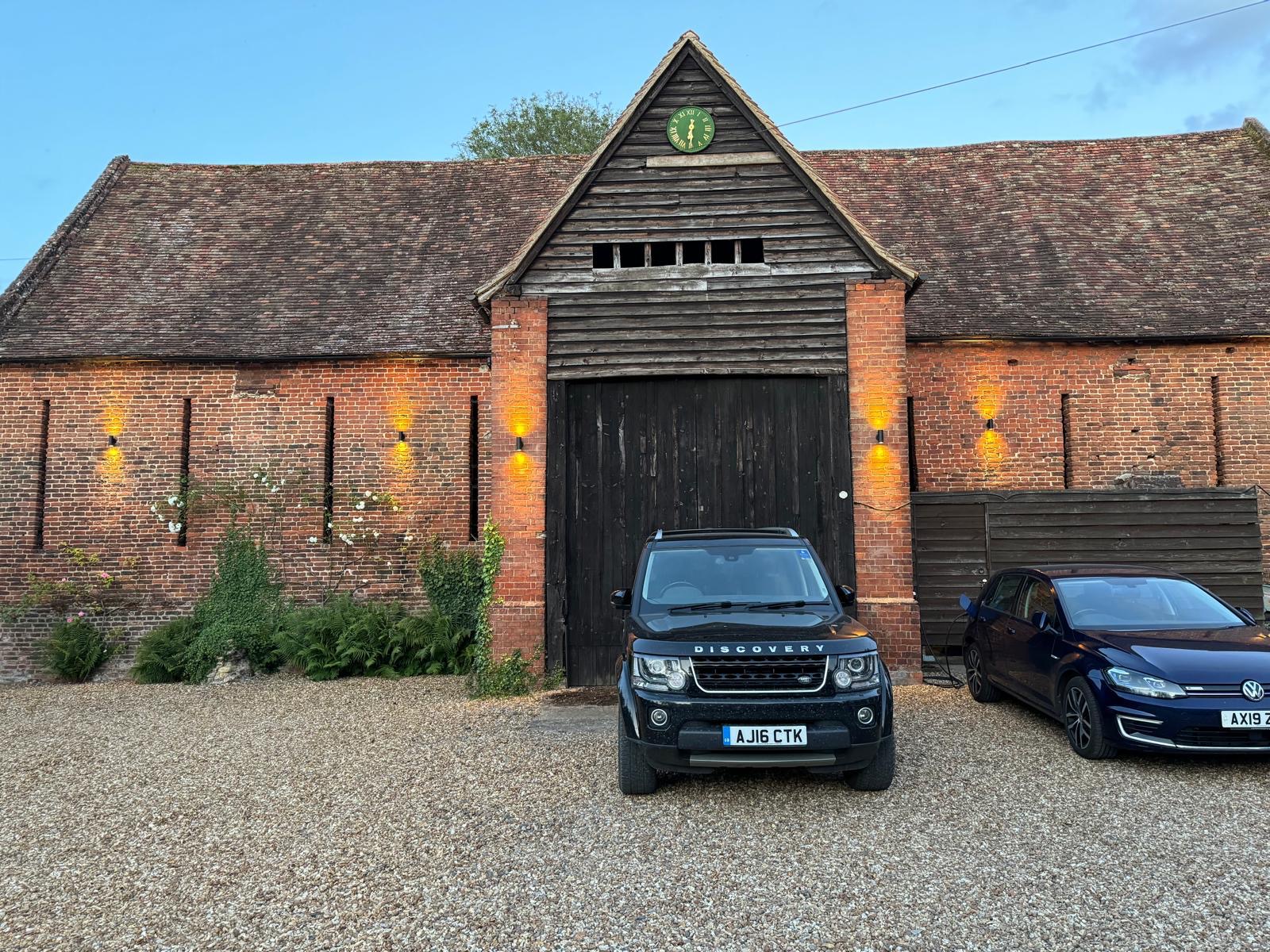 Up-and-down wall lights on a brick barn conversion