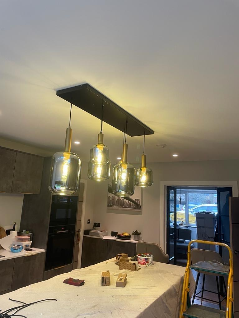 Four pendant lights over a kitchen island