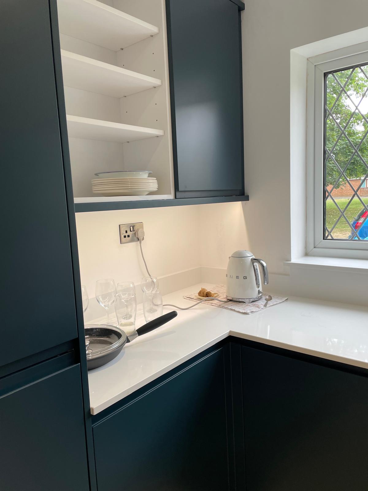 Under-cabinet lighting and a socket on a kitchen worktop